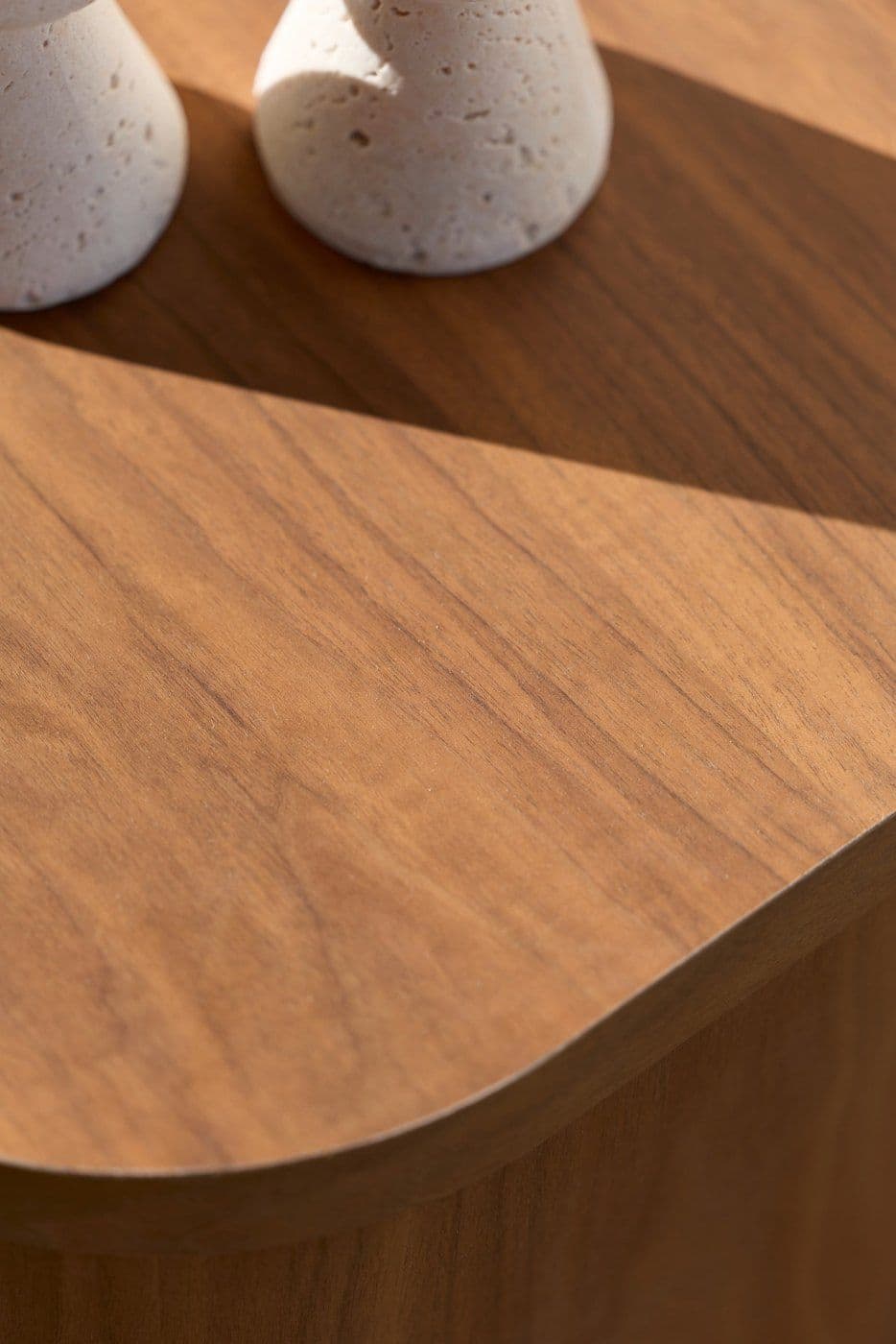 Close-up of a walnut veneer surface with a rounded edge